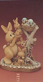 Bunny reaching with birds in nest set